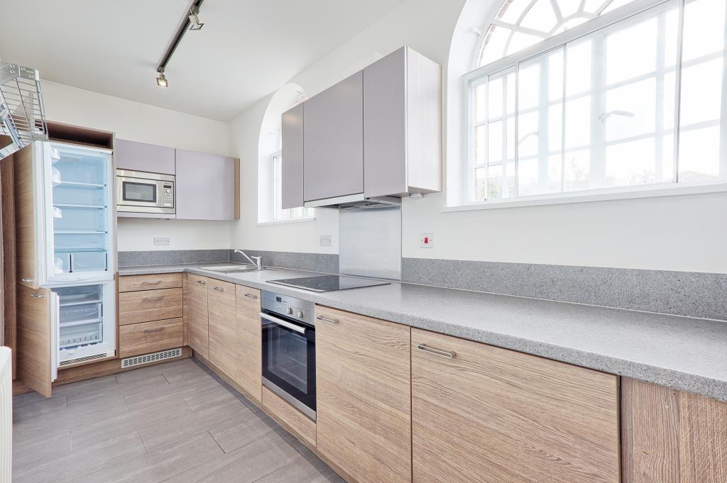 Lot: 6 - ATTRACTIVE TWO-BEDROOM APARTMENT IN CONVERTED FORMER HOSPITAL BUILDING - Kitchen with laminate flooring with bay window and cabinets